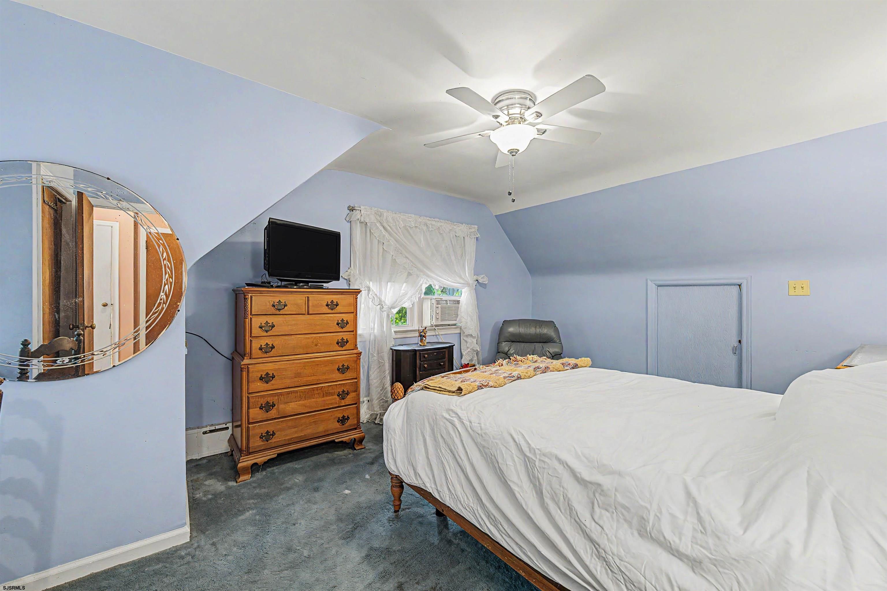 144 Pitney Road Absecon, NJ 08201 - Photo 29 of 47 a bedroom with a bed and a flat tv screen on dresser