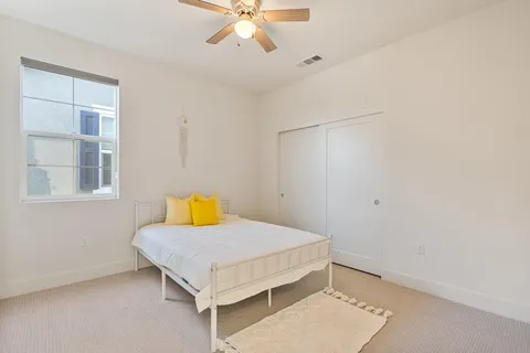 a bedroom with a bed and a chandelier