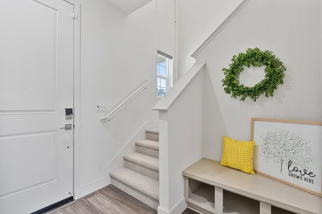 a view of entryway and hall with wooden floor