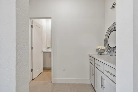 a bathroom with a light fixture a sink and a mirror