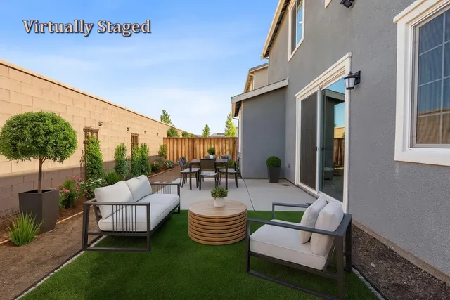 a view of a patio with couches and a potted plant on a table
