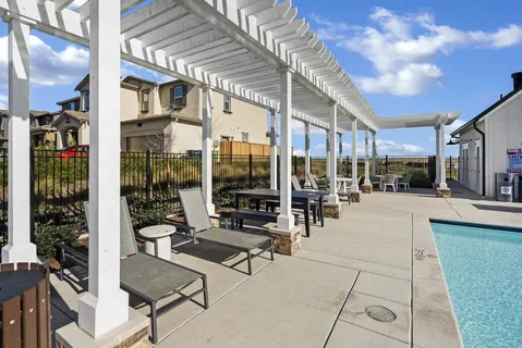 a building outdoor space with patio furniture and potted plants