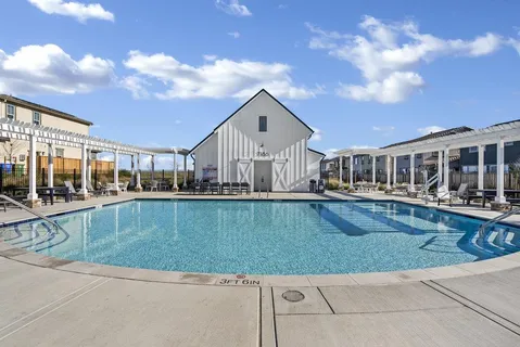 a view of a house with swimming pool and sitting area