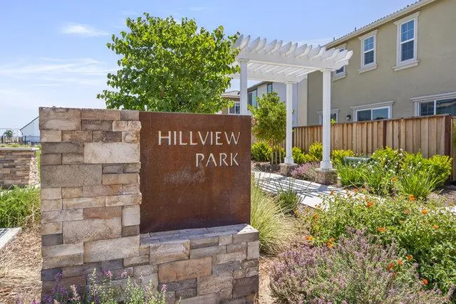 a sign board with a building in the background