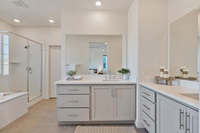 a spacious bathroom with a double vanity sink mirror double and shower