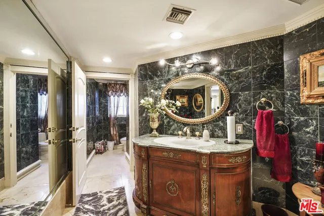 a bathroom with a sink mirror vanity and bathtub