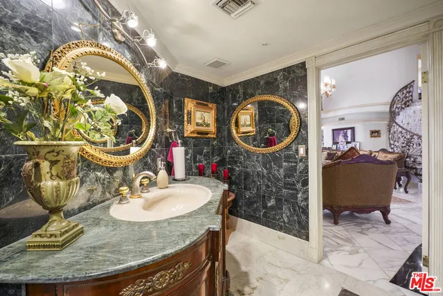 a bathroom with a sink mirror vanity and a mirror