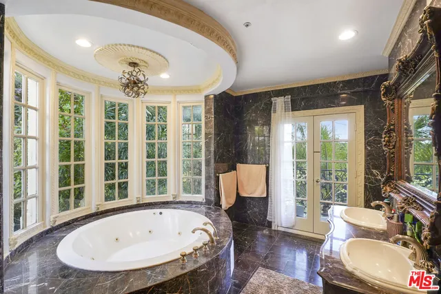 a view of a livingroom with furniture and a large window