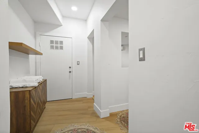 a view of a livingroom with wooden floor and a sink