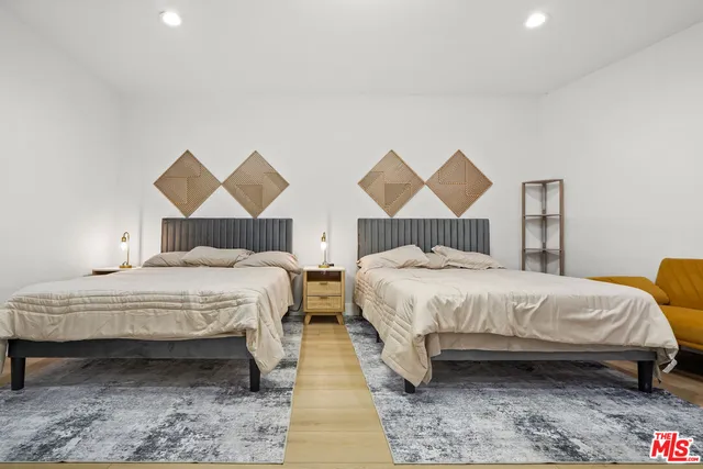 a bedroom with a bed and a painting on the wall