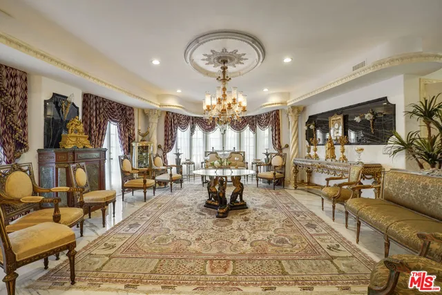 a living room with lots of furniture and view of kitchen