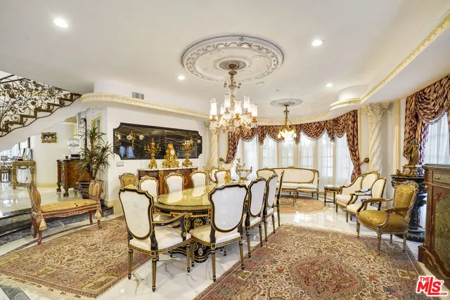 a view of a dining room with furniture and chandelier