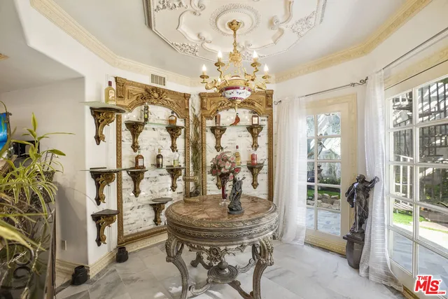 a view of a dining room with furniture and a chandelier