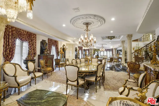 a view of a dining room with furniture a chandelier and wooden floor