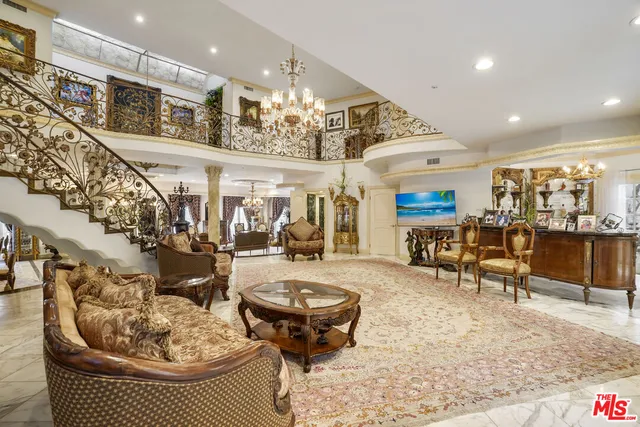 a living room with furniture and a chandelier