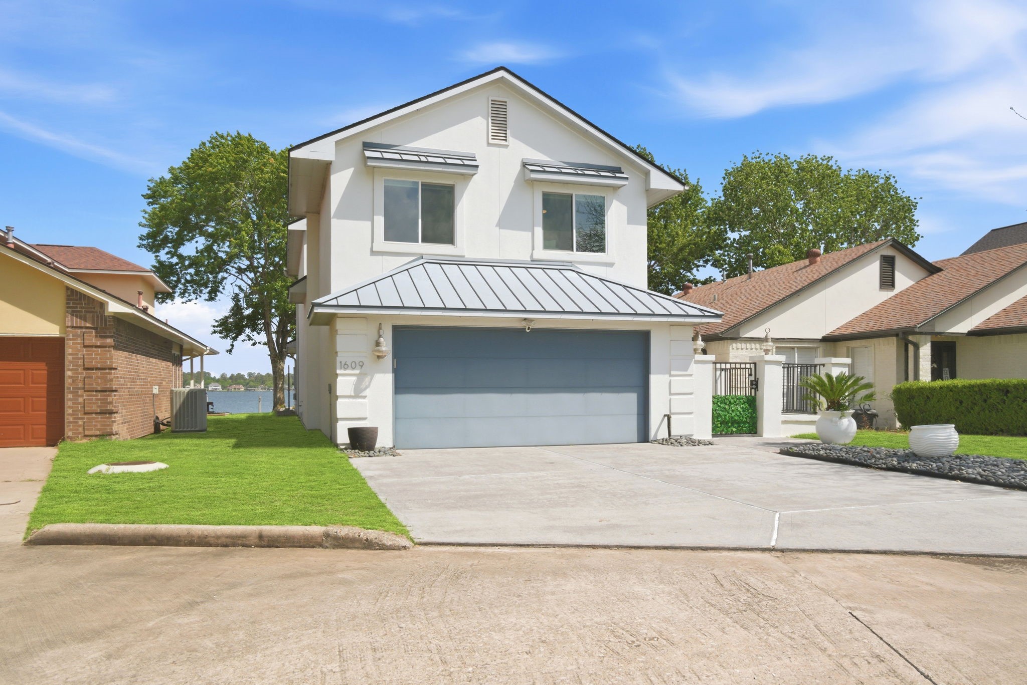 1609 Schooner Point Willis, TX 77318 - Photo 2 of 50 a front view of a house with a yard and garage