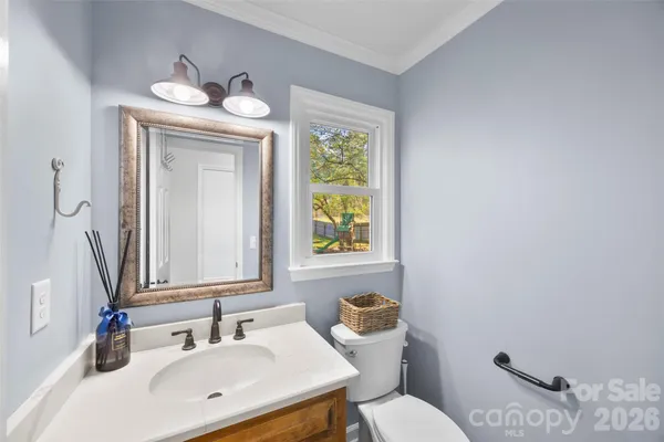 a bathroom with a toilet a sink and mirror