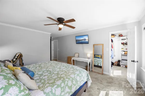 a bedroom with a bed and a desk