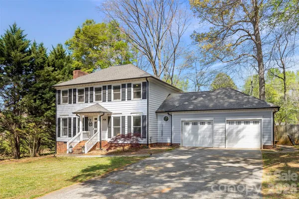 a front view of a house with a yard outdoor seating and garage