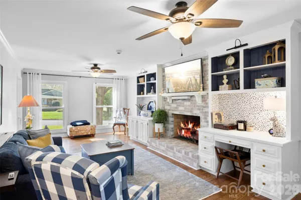 a living room with furniture fireplace and a flat screen tv