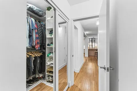 a view of hallway with wooden floor and stairs