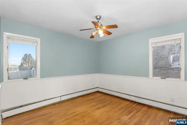 a view of a room with wooden floor and a window