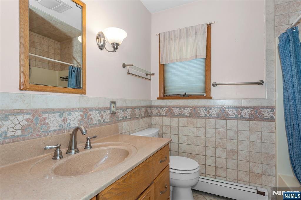 86 Reservoir Avenue Butler, NJ 07405 - Photo 15 of 32 a bathroom with a sink and a toilet