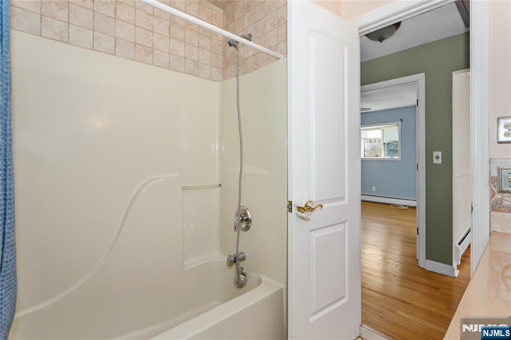 86 Reservoir Avenue Butler, NJ 07405 - Photo 16 of 32 a bathroom with a bathtub