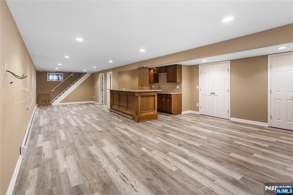 86 Reservoir Avenue Butler, NJ 07405 - Photo 17 of 32 an empty room with wooden floor and electronic appliances