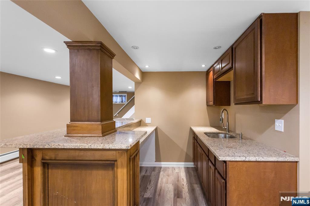 86 Reservoir Avenue Butler, NJ 07405 - Photo 22 of 32 a kitchen with a granite countertop sink a stove and a microwave