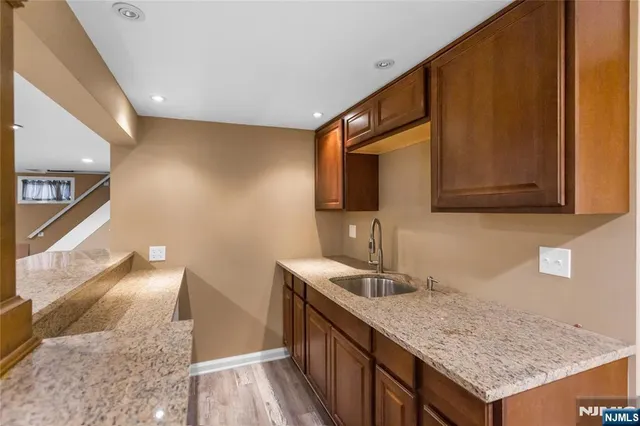 a kitchen with granite countertop sink and cabinets