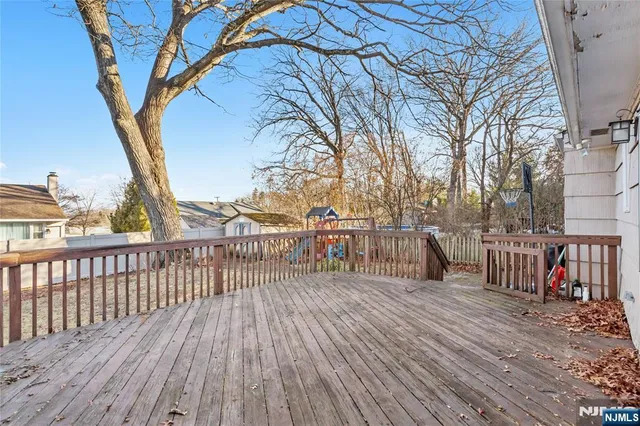 a view of a balcony with wooden floor and fence