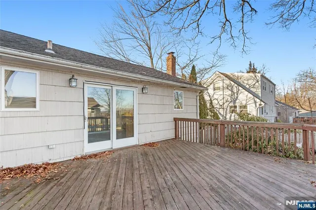 a view of a house with a wooden deck