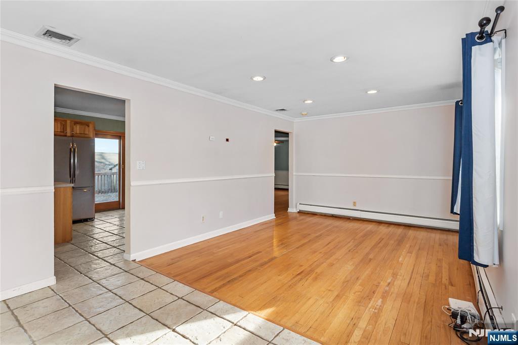 86 Reservoir Avenue Butler, NJ 07405 - Photo 4 of 32 a view of an empty room with wooden floor and a window