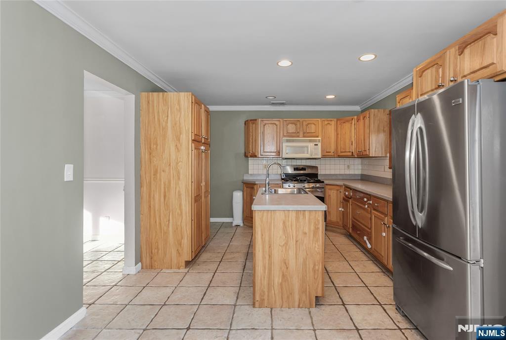 86 Reservoir Avenue Butler, NJ 07405 - Photo 6 of 32 a kitchen with stainless steel appliances granite countertop a refrigerator and a stove top oven