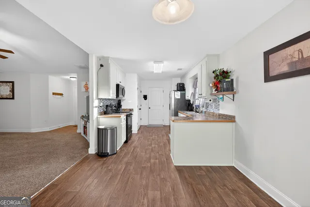 a kitchen with a refrigerator and a stove top oven