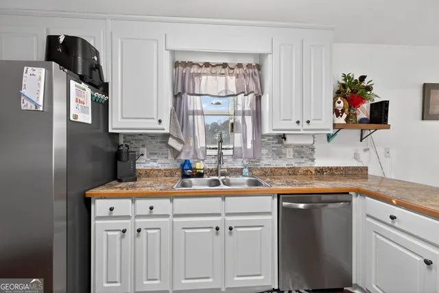 a kitchen with stainless steel appliances granite countertop a sink stove and cabinets