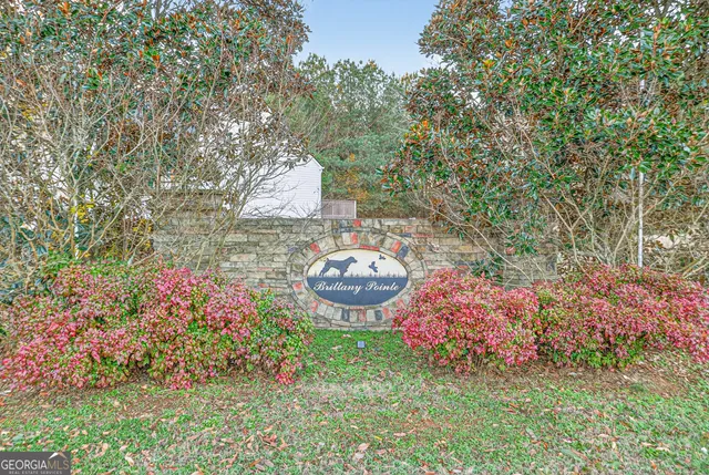 a view of a backyard with table and chairs and potted plants