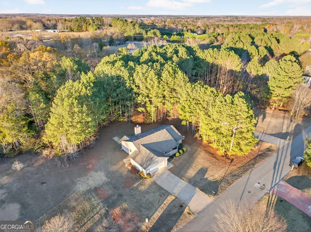 an aerial view of a house with a yard