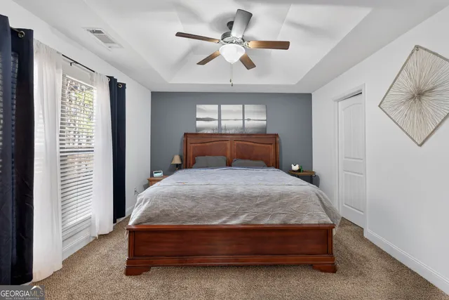 a bedroom with a bed and window