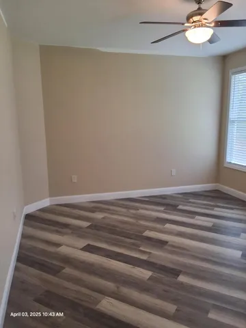 a view of room with window and ceiling fan