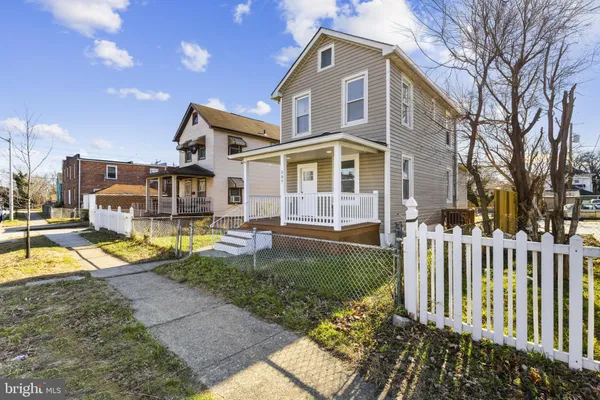 a front view of a house with a yard table and chairs