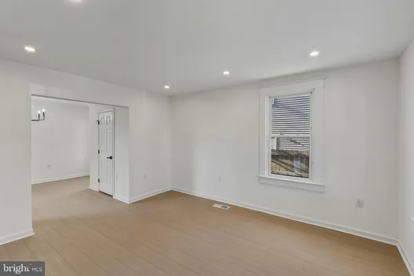 an empty room with a empty space and windows