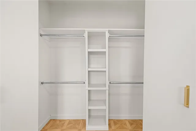 a view of walk in closet with empty racks