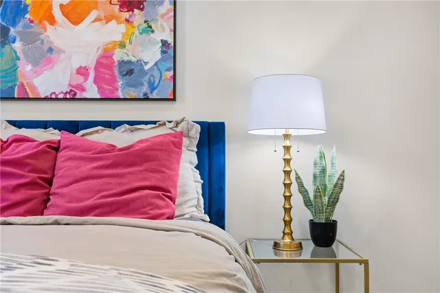 a bedroom with a bed and a potted plant