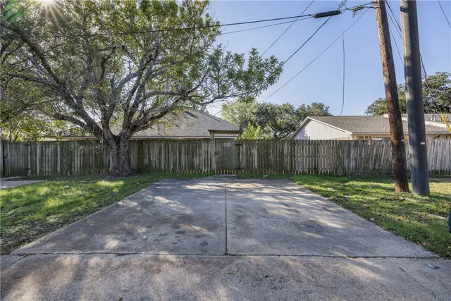 a view of a backyard with wooden fence