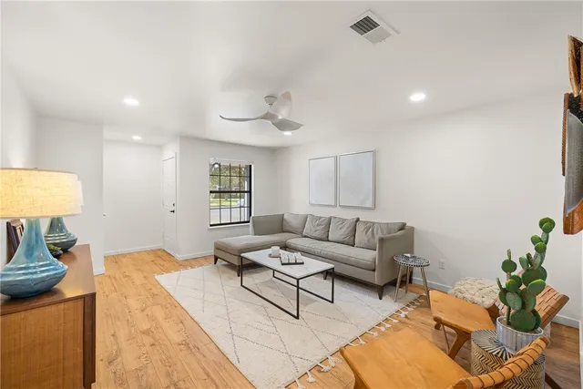 a living room with furniture and a lamp