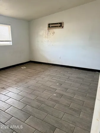 a view of a room with wooden floor