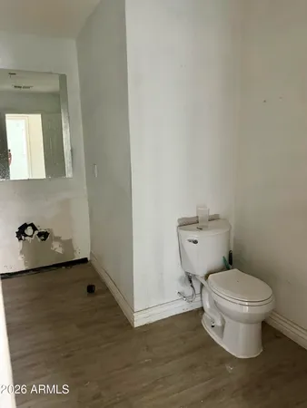 a white toilet sitting next to a sink