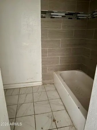 a bathroom with a granite countertop shower